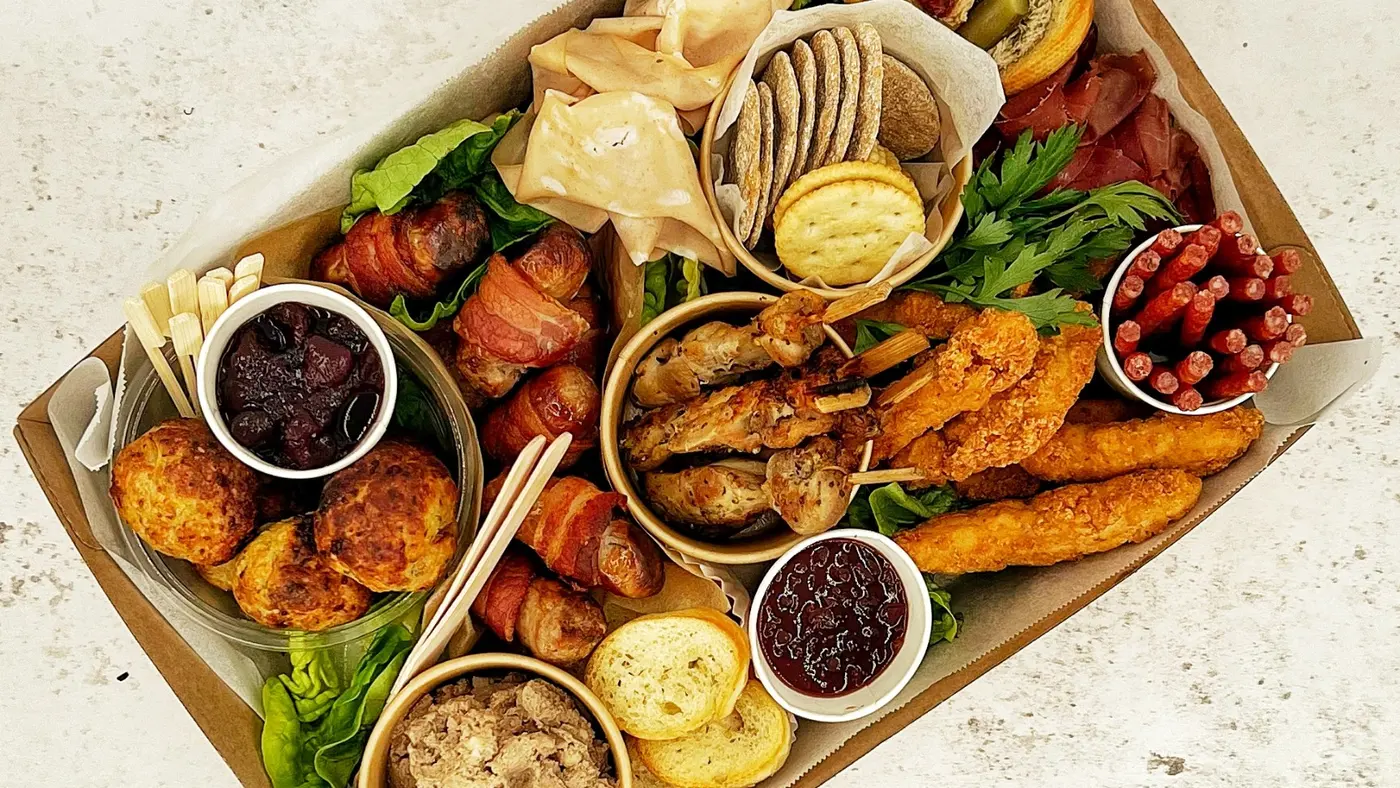 A delicious platter box filled with various snacks and dips, perfect for events.