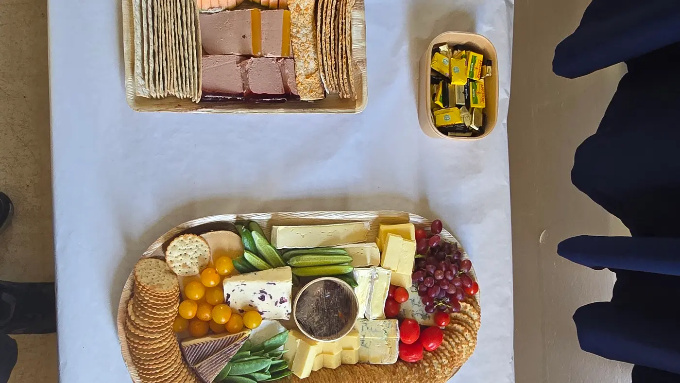 A beautifully arranged buffet spread featuring charcuterie, cheese, bread, and accompaniments.