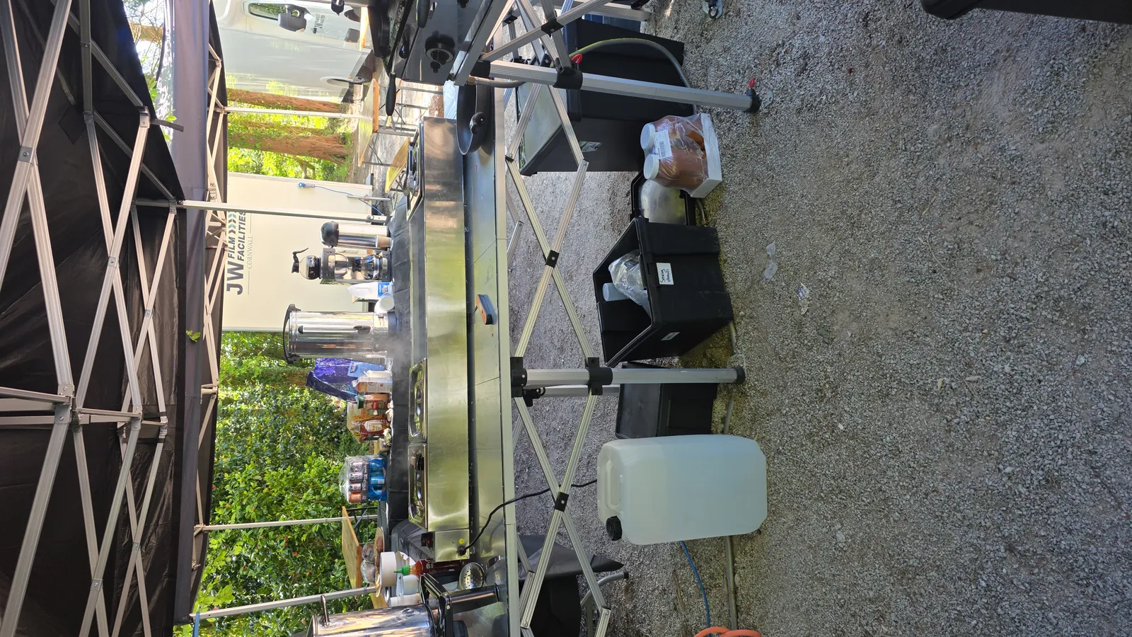 Salt Wind Catering mobile kitchen and hot servery set up under the gazebo at a Cornwall unit base, alongside JW Film Facilities units