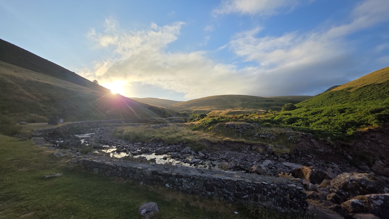 Sunrise over a remote Welsh mountain valley at the 07:00 catering pre-call
